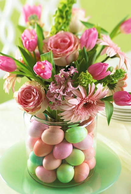 Easter eggs in vase with flowers